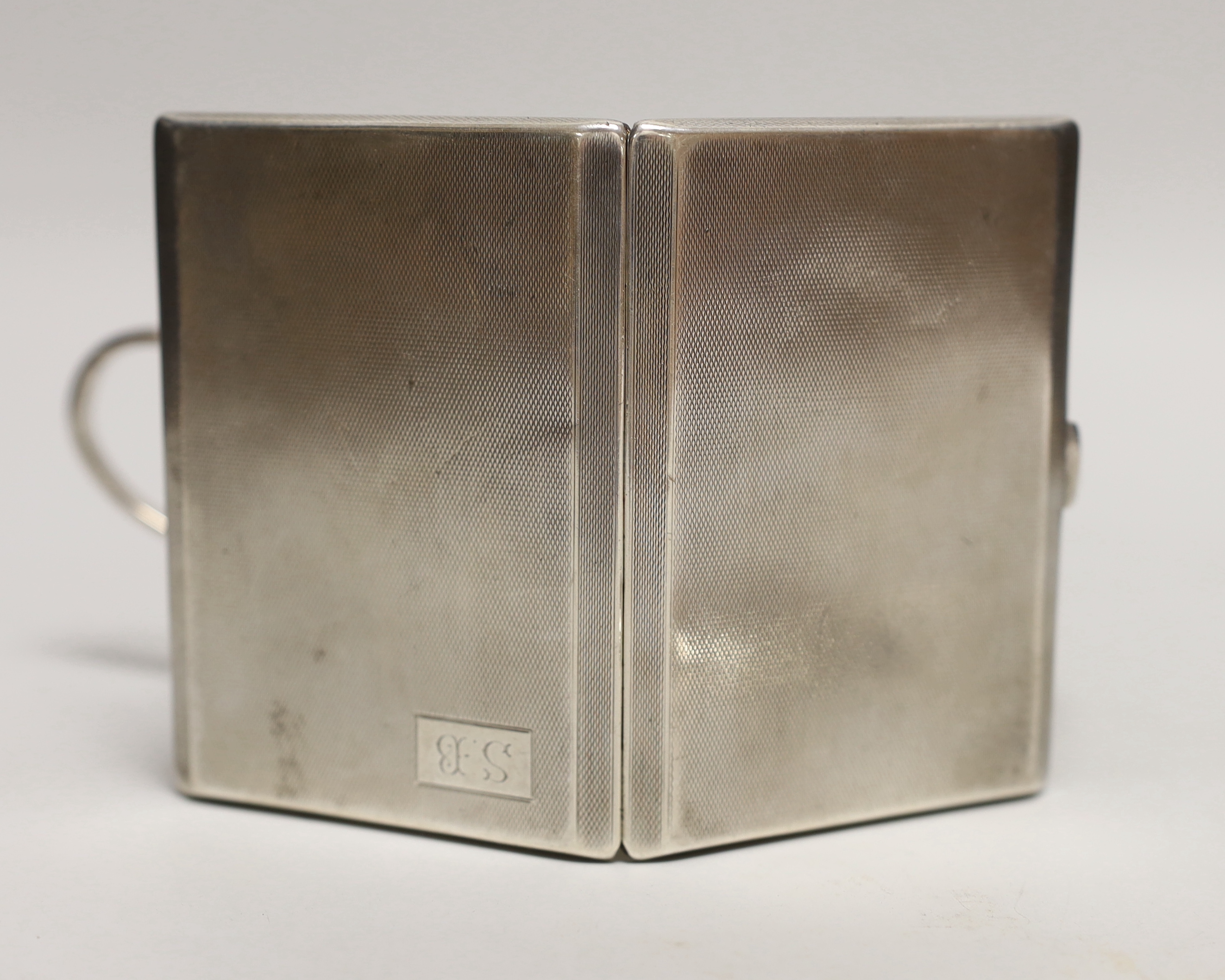 A George V engine turned silver cigarette case, 11.3cm a white metal sauceboat and a Wai Kee sterling pin dish.